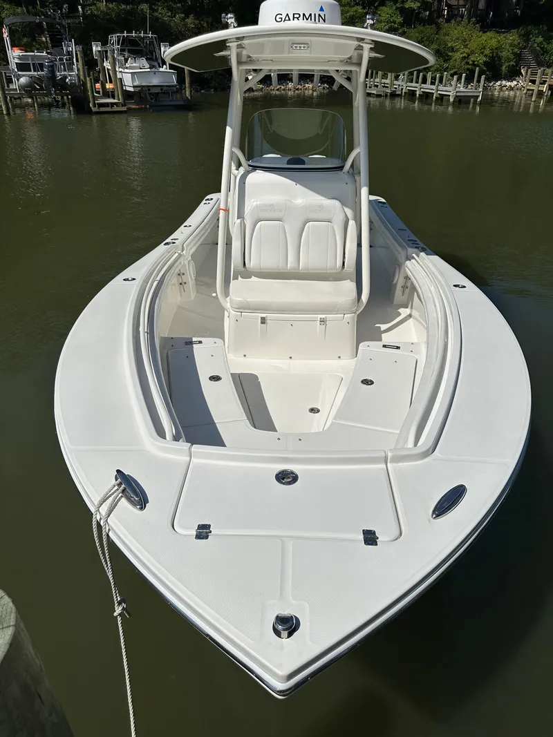 Slide: The Image of 2019 Regulator 23 FS boat docked on calm water. - 11