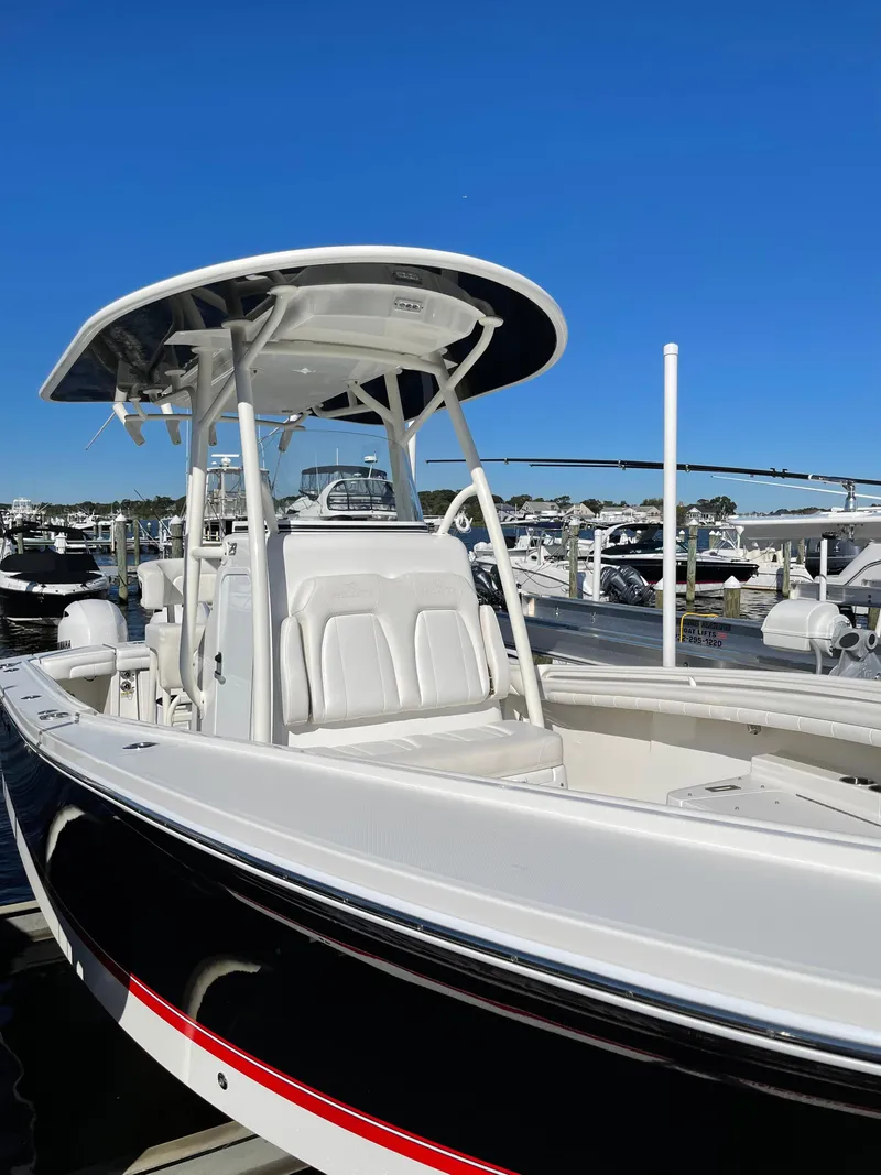 Slide: The Image of 2019 Regulator 23 FS boat docked under clear blue sky. - 12