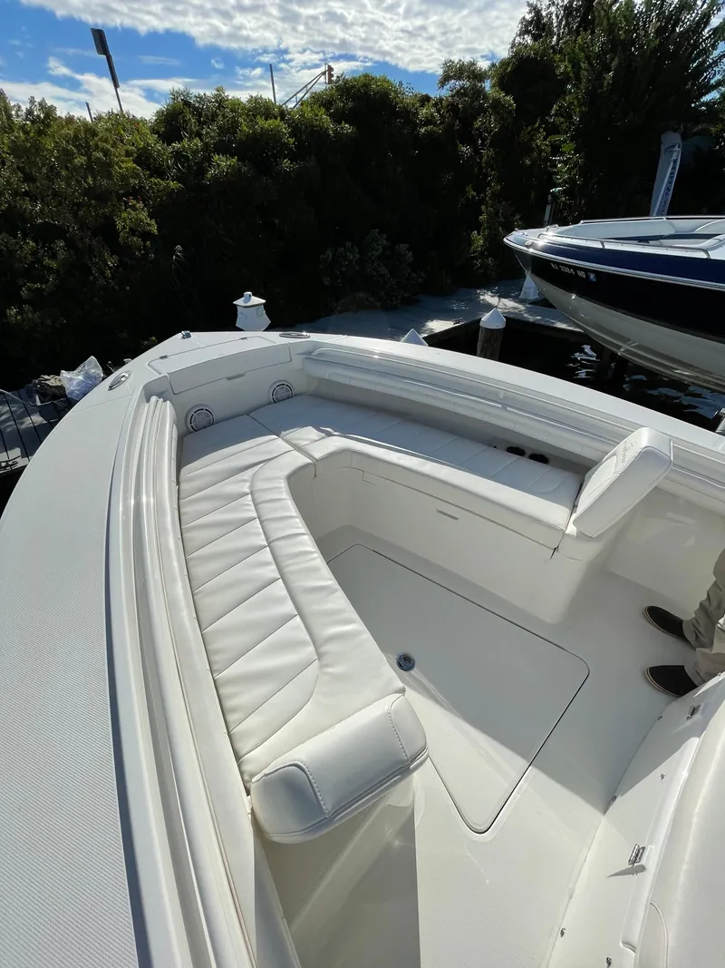 Slide: The Image of 2019 Regulator 23 FS boat with white seating and spacious deck. - 16