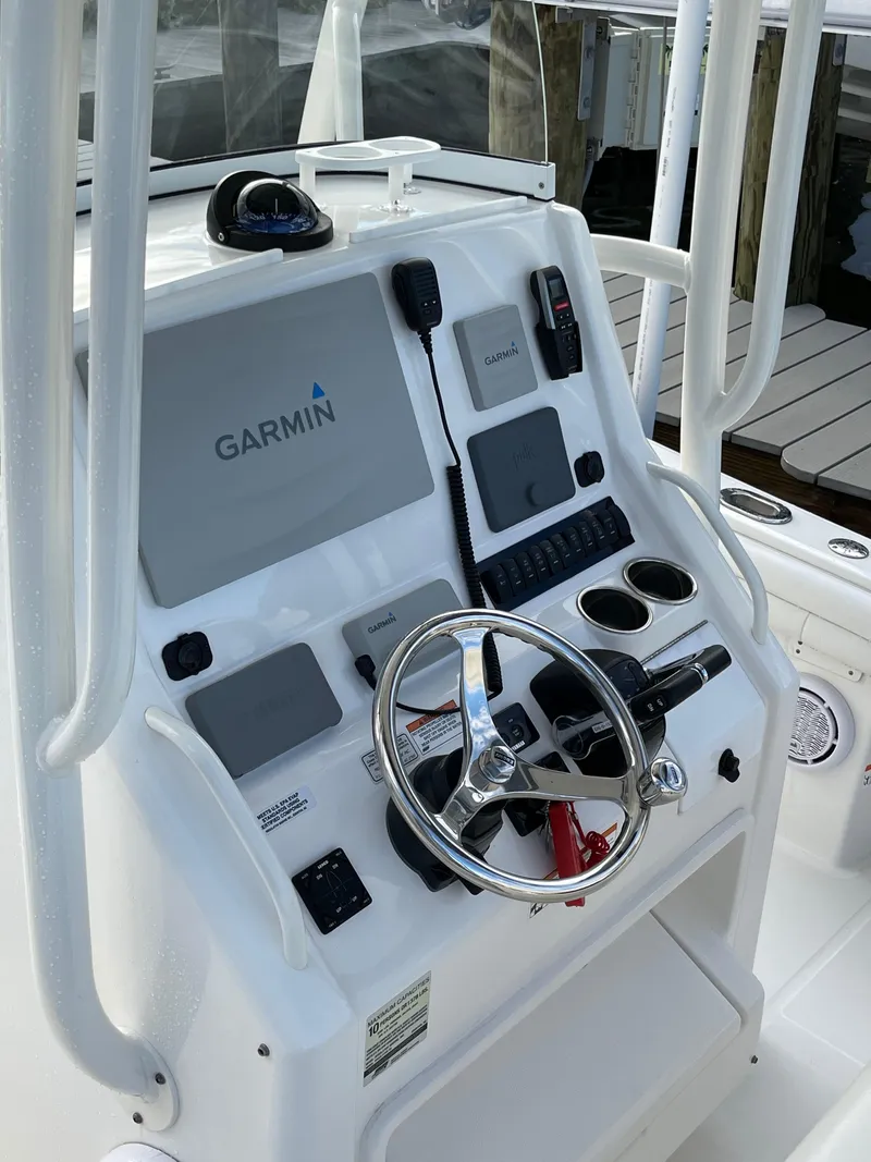 Slide: The Image of 2019 Regulator 23 FS boat console with Garmin navigation system and steering wheel. - 17