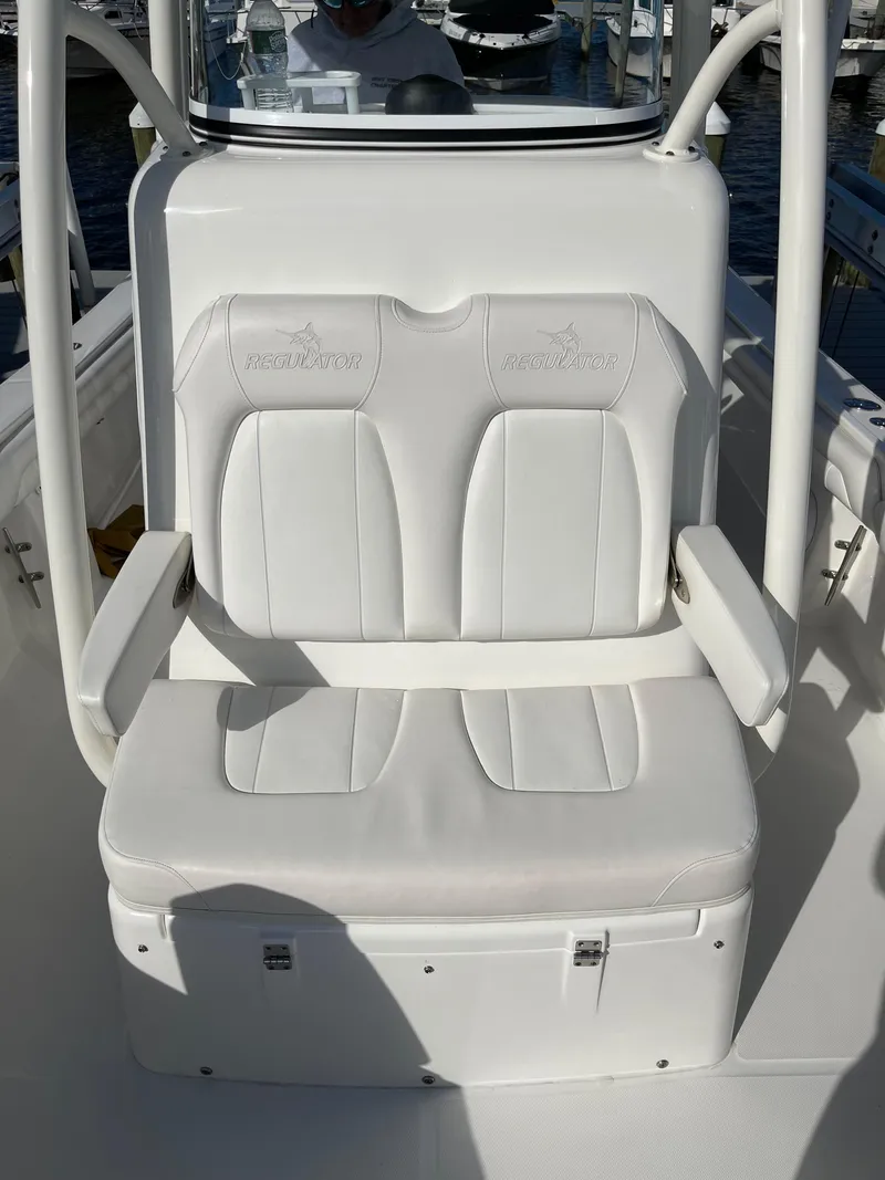 Slide: The Image of 2019 Regulator 23 FS boat with white cushioned seating. - 19
