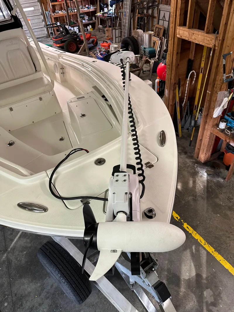 Slide: The Image of 2019 Regulator 23 FS boat with trolling motor in a workshop setting. - 20