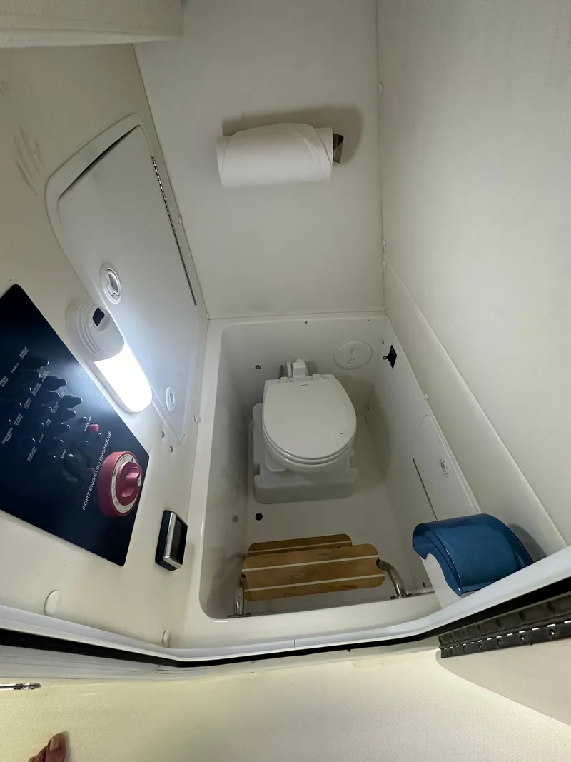 Slide: The Image of 2019 Regulator 23 FS boat interior with toilet and control panel. - 21