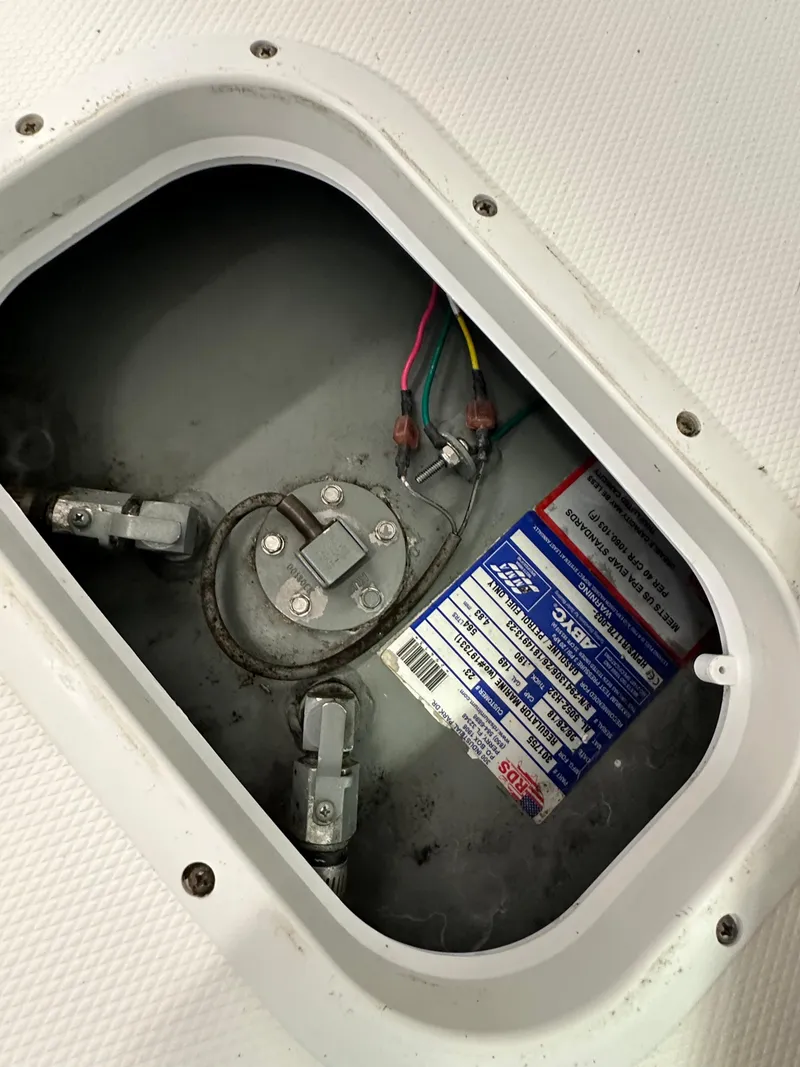 Slide: The Image of 2019 Regulator 23 FS boat fuel tank compartment with wiring and label. - 25