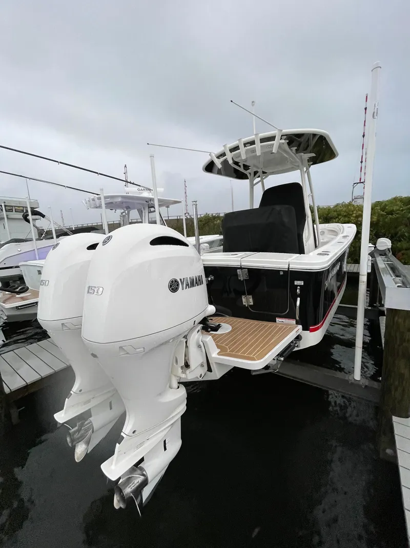 Slide: The Image of 2019 Regulator 23 FS boat with twin Yamaha outboard engines at dock. - 5