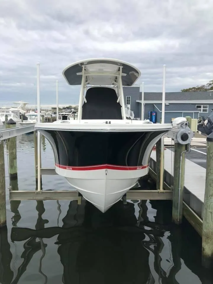 Slide: The Image of 2019 Regulator 23 FS boat docked at marina, front view. - 6