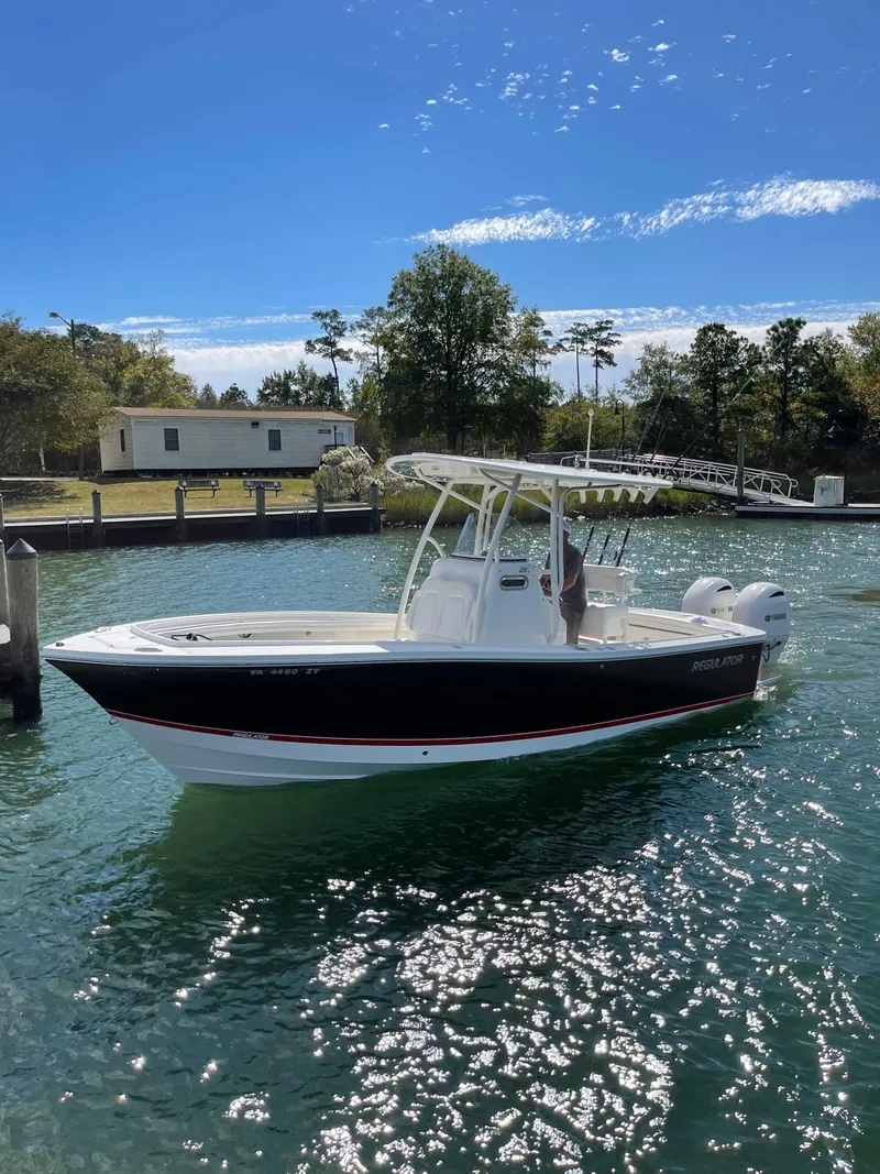 Slide: The Image of 2019 Regulator 23 FS boat on clear water under blue sky. - 7