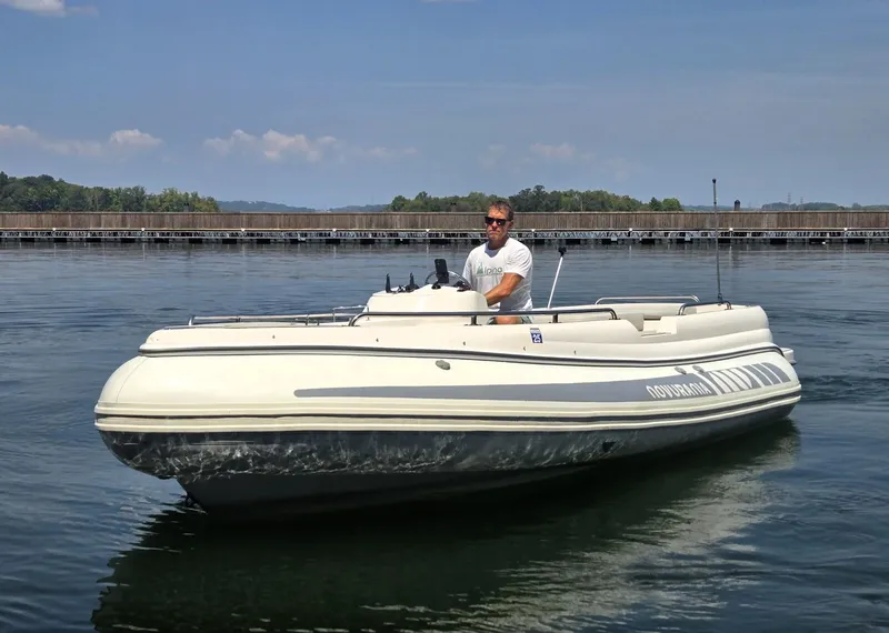 Slide: The Image of 2007 Novurania 6.0 Custom boat on calm water with driver. - 2