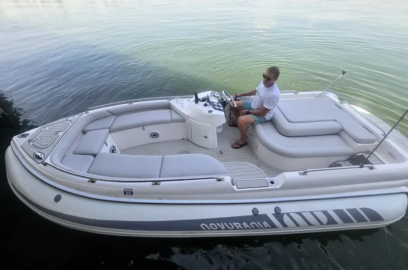 Slide: The Image of 2007 Novurania 6.0 Custom boat on calm water with driver. - 3