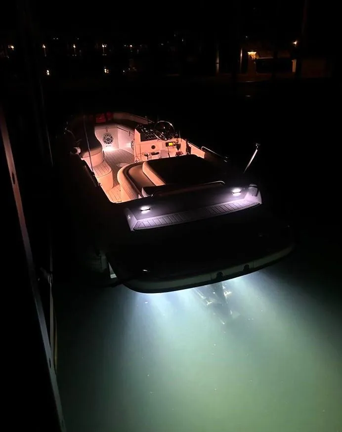 Slide: The Image of 2007 Novurania 6.0 Custom boat illuminated at night on water. - 6