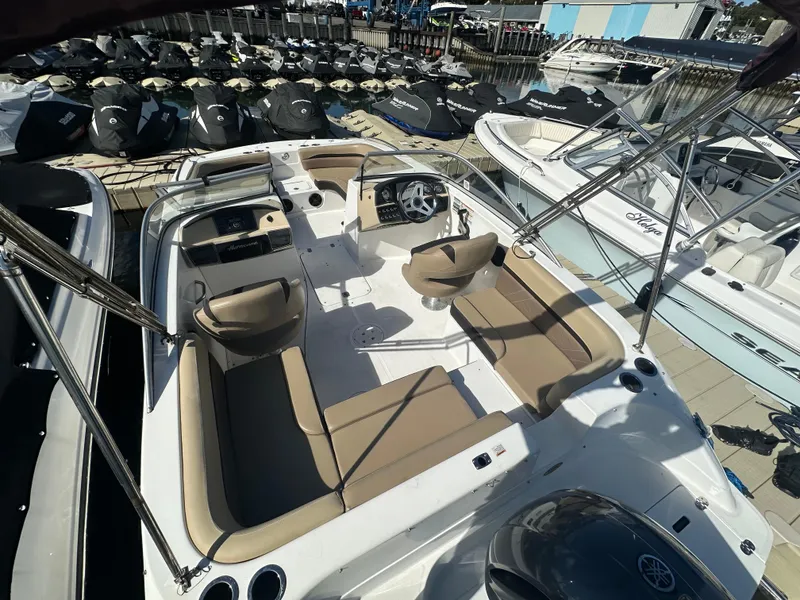 Slide: The Image of 2019 Hurricane SD191 boat with beige seating, docked among other boats. - 6