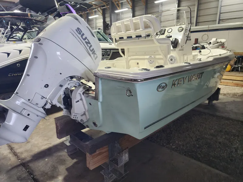 Slide: The Image of 2025 Key West 1720 Center Console boat with Suzuki outboard motor in a storage facility. - 3