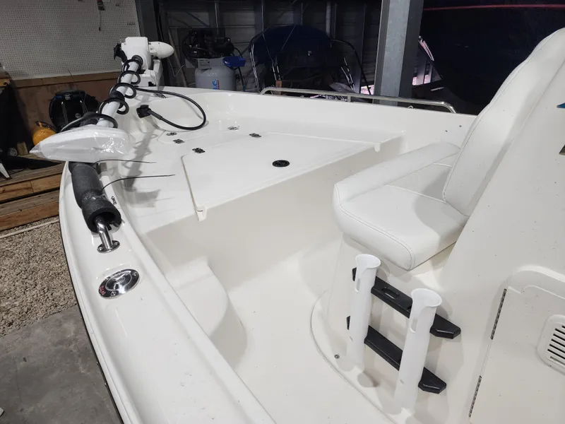 Slide: The Image of 2025 Key West 1720 Center Console boat interior with seating and rod holders. - 5