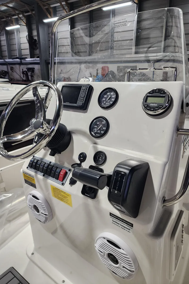 Slide: The Image of 2025 Key West 1720 Center Console boat dashboard with steering wheel and gauges. - 7