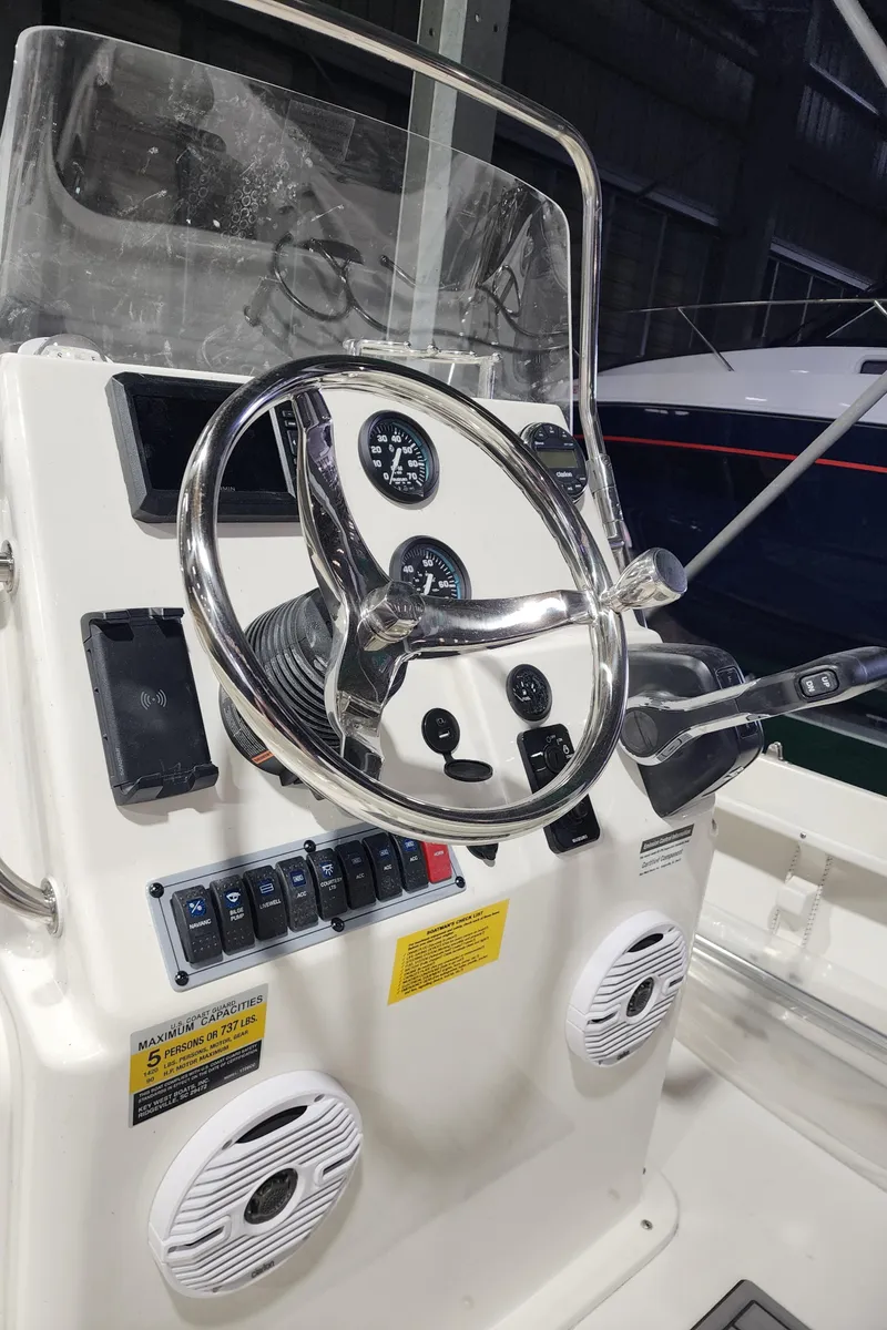 Slide: The Image of 2025 Key West 1720 Center Console boat steering wheel and dashboard controls. - 8