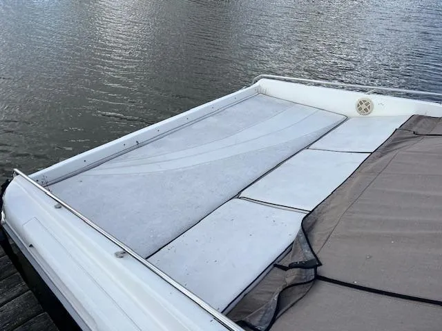 Slide: The Image of 1996 Sea Ray 380 Sun Sport boat deck by the water. - 3