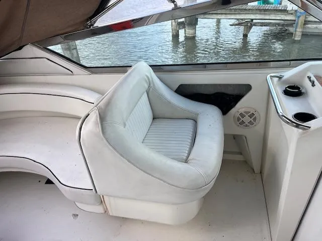 Slide: The Image of Interior seating of 1996 Sea Ray 380 Sun Sport boat by the water. - 7