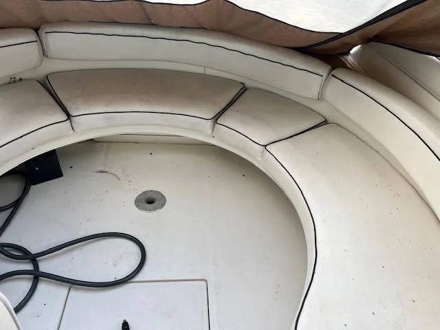 Slide: The Image of 1996 Sea Ray 380 Sun Sport boat interior with white seating and storage. - 8