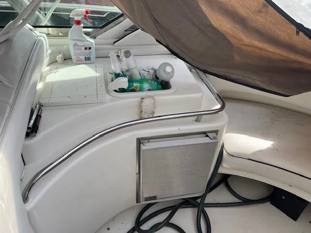 Slide: The Image of 1996 Sea Ray 380 Sun Sport boat interior with cleaning supplies and storage area. - 9
