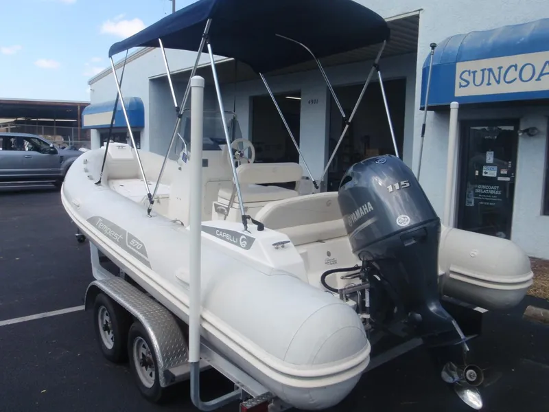 Slide: The Image of 2016 Capelli Tempest 570 inflatable boat with Yamaha 115 engine on trailer. - 2