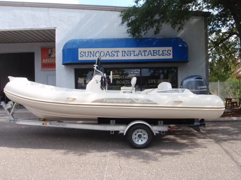 Slide: The Image of 2016 Capelli Tempest 570 inflatable boat on trailer outside Suncoast Inflatables store. - 3