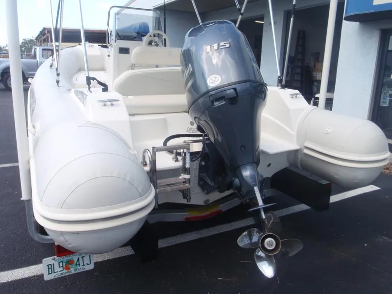 Slide: The Image of 2016 Capelli Tempest 570 boat with Yamaha 115 outboard motor, parked on pavement. - 4