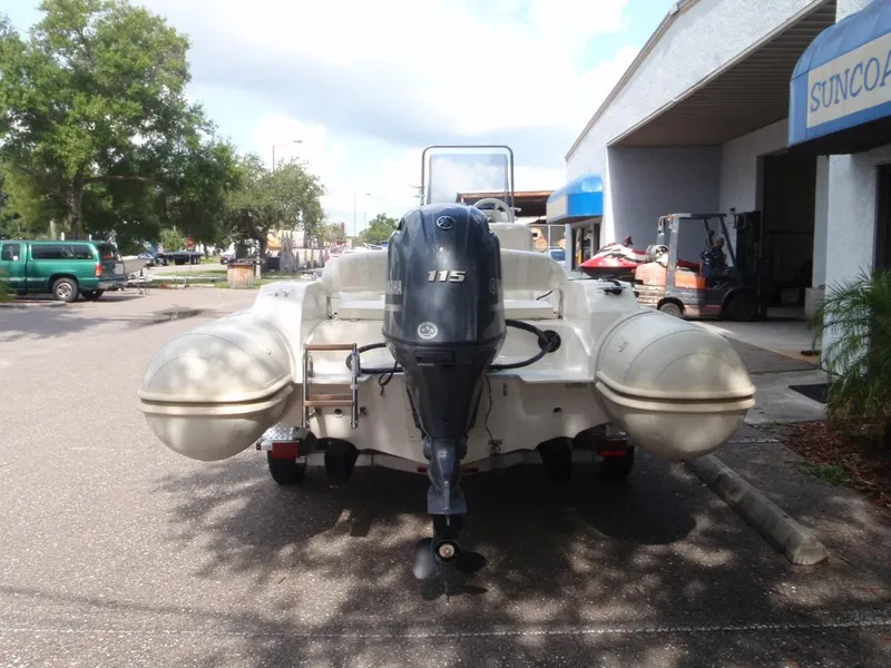 Slide: The Image of 2016 Capelli Tempest 570 inflatable boat with outboard motor, parked outdoors. - 5