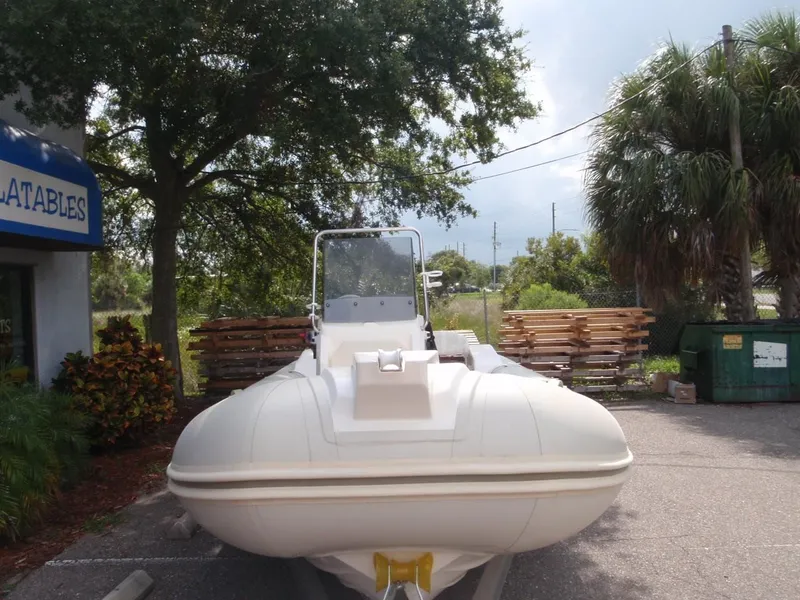 Slide: The Image of 2016 Capelli Tempest 570 inflatable boat parked outdoors near trees. - 7