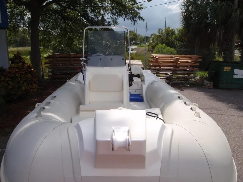 Slide: The Image of 2016 Capelli Tempest 570 inflatable boat, white, parked outdoors. - 8