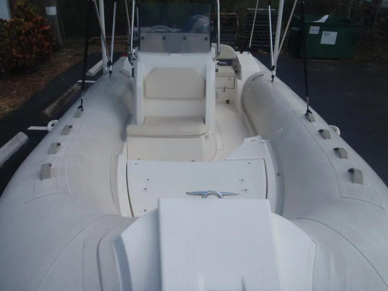 Slide: The Image of 2016 Capelli Tempest 570 inflatable boat, white interior, spacious seating, and steering console. - 9