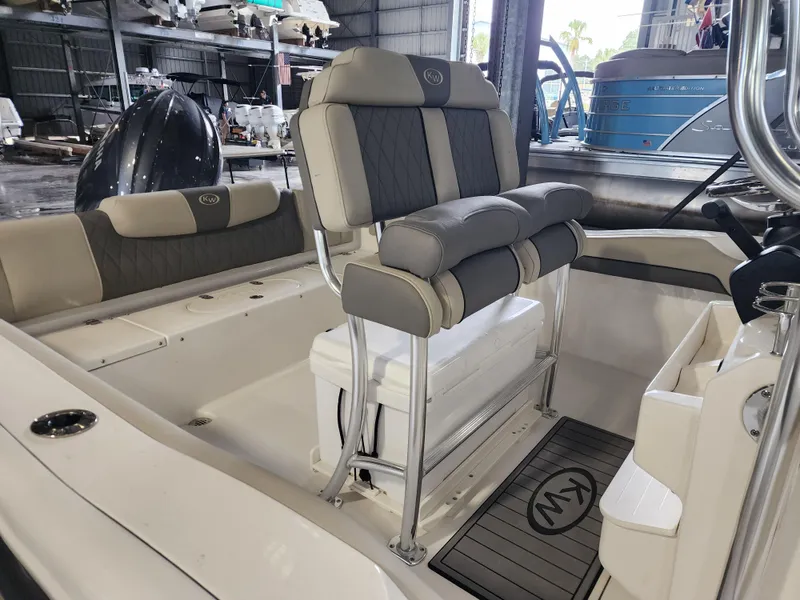 Slide: The Image of 2025 Key West 219 FS boat interior with cushioned seating and storage. - 2