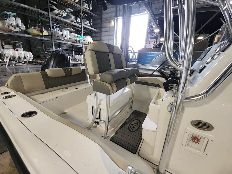 Slide: The Image of 2025 Key West 219 FS boat interior with seating and console in a storage facility. - 3