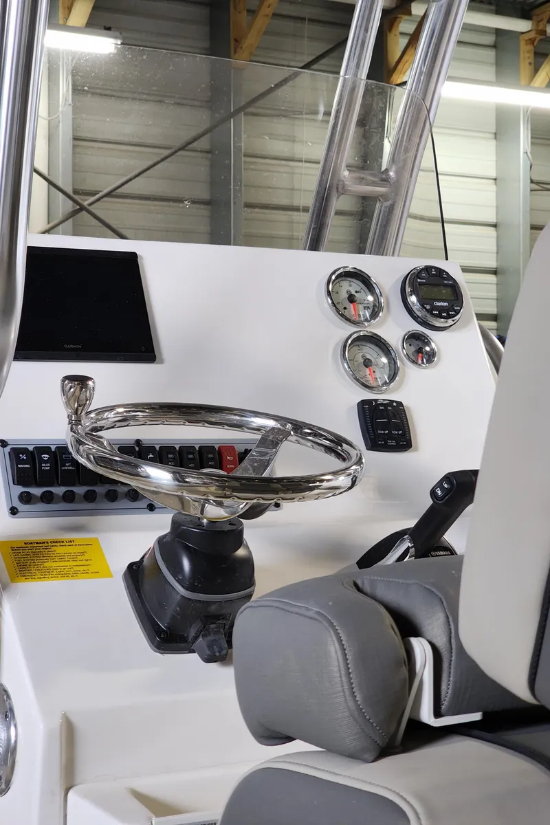 Slide: The Image of 2025 Key West 219 FS boat dashboard with steering wheel and gauges. - 5