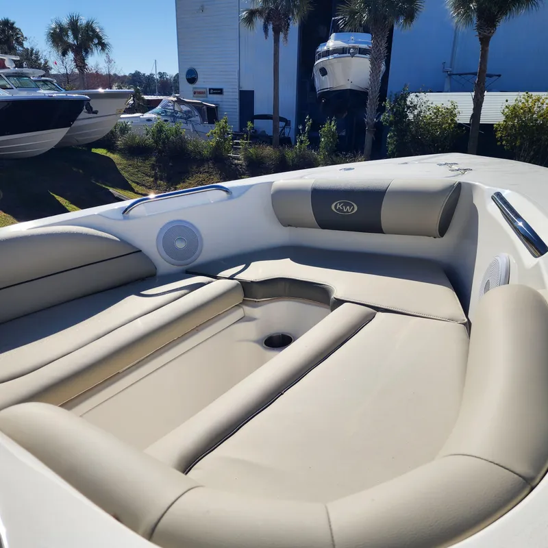 Slide: The Image of 2025 Key West 203 DFS boat interior with cushioned seating and speakers. - 13