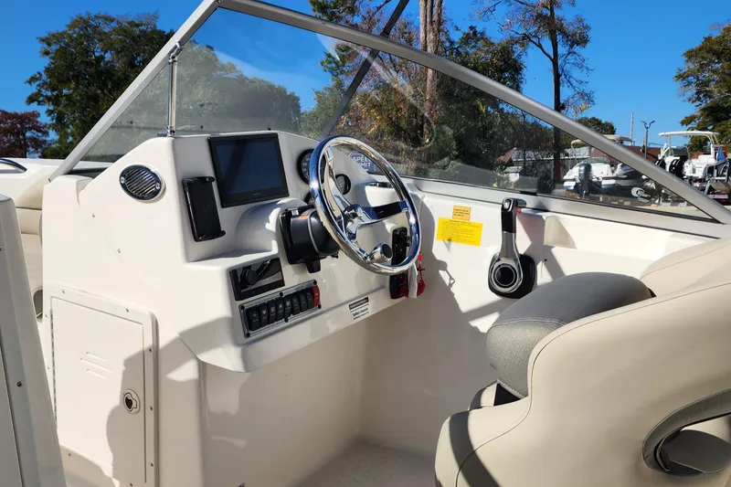 Slide: The Image of 2025 Key West 203 DFS boat cockpit with steering wheel and control panel. - 3