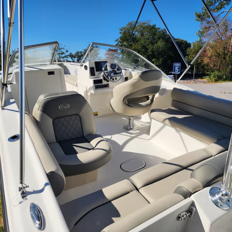 Slide: The Image of 2025 Key West 203 DFS boat interior with modern seating and steering wheel. - 4