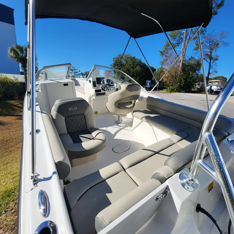 Slide: The Image of 2025 Key West 203 DFS boat interior with seating and steering wheel under canopy. - 5