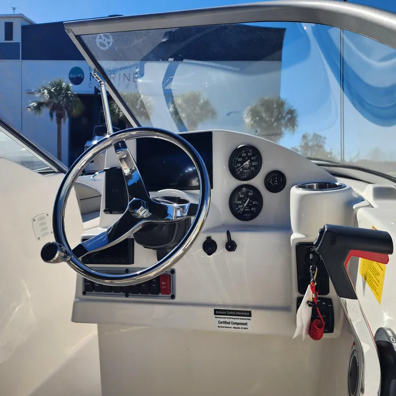 Slide: The Image of 2025 Key West 203 DFS boat dashboard with steering wheel and gauges. - 6