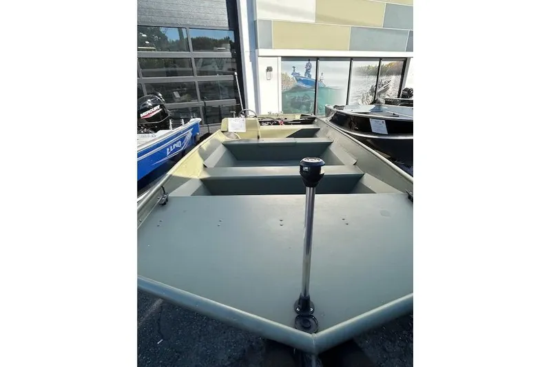 Slide: The Image of 2024 Lund 1852MT boat displayed outdoors, featuring a minimalist design and sturdy construction. - 2