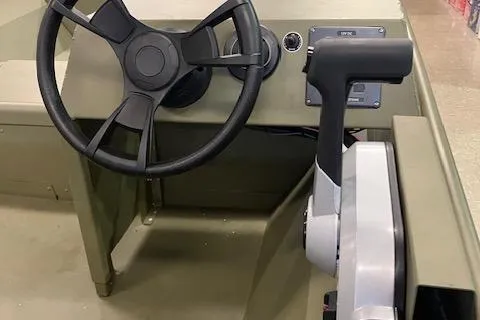 Slide: The Image of 2024 Lund 1852MT boat interior with steering wheel and control panel. - 4