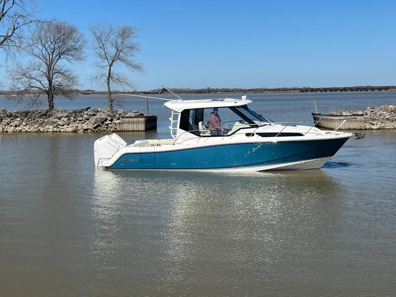 The Image of 2025 Boston Whaler 325 Conquest boat on calm water, clear sky background. - 0