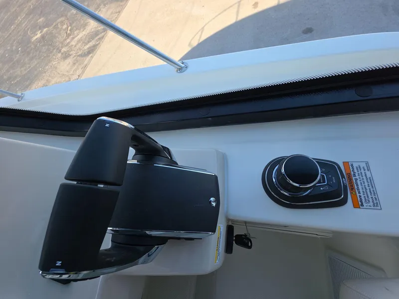 Slide: The Image of Control panel of 2025 Boston Whaler 325 Conquest boat, featuring steering and throttle controls. - 14