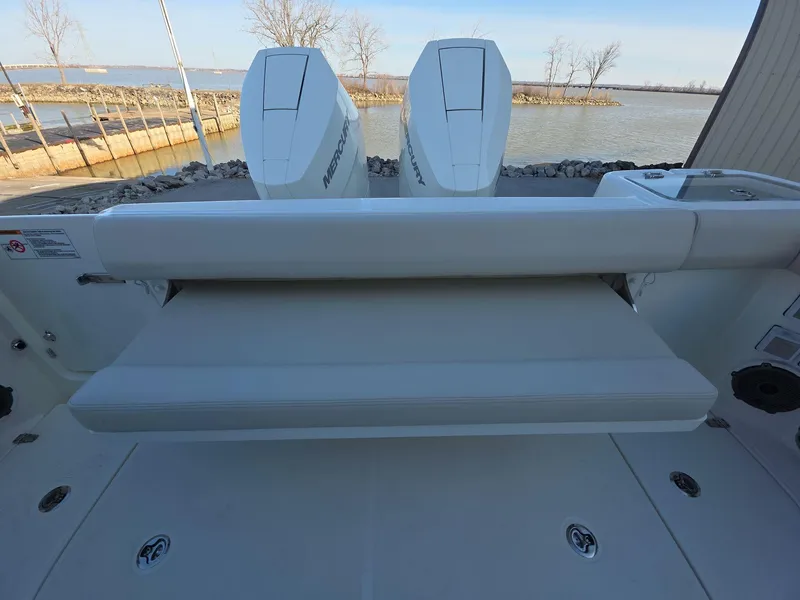 Slide: The Image of 2025 Boston Whaler 325 Conquest boat with dual engines and cushioned seating. - 17
