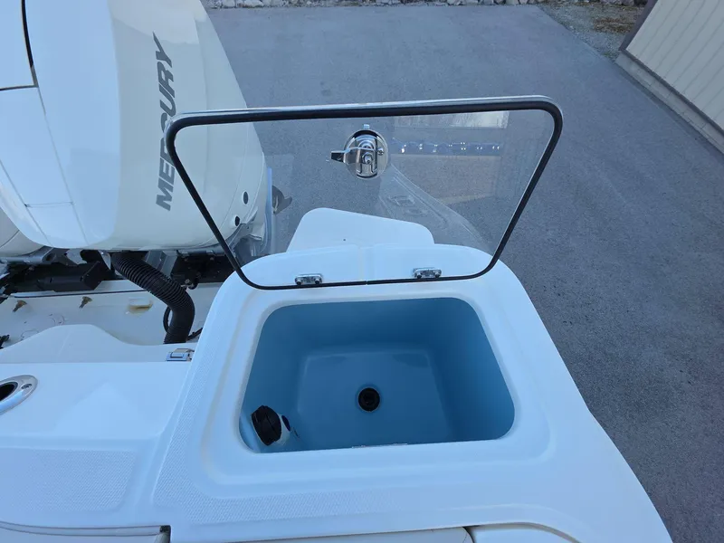 Slide: The Image of Boston Whaler 325 Conquest 2025 livewell with open lid, showcasing interior. - 19