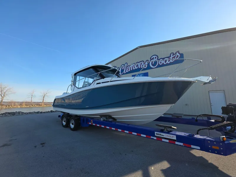 Slide: The Image of 2025 Boston Whaler 325 Conquest boat on trailer at Clemons Boats dealership. - 2