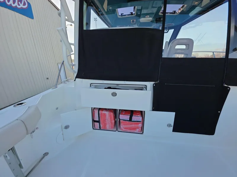 Slide: The Image of 2025 Boston Whaler 325 Conquest interior with storage compartments and seating. - 20