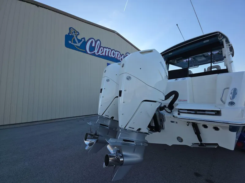 Slide: The Image of 2025 Boston Whaler 325 Conquest with dual engines at Clemons Boats dealership. - 6