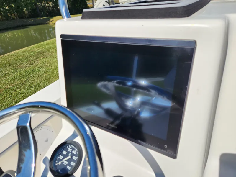 Slide: The Image of 2023 May-Craft 208 CC boat dashboard with steering wheel and display screen. - 12