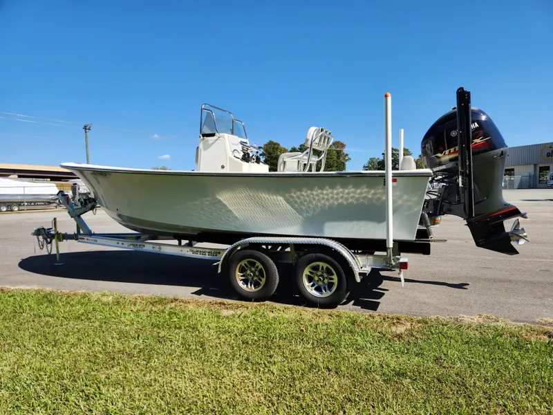 Slide: The Image of 2023 May-Craft 208 CC boat on trailer, parked outdoors under clear blue sky. - 5