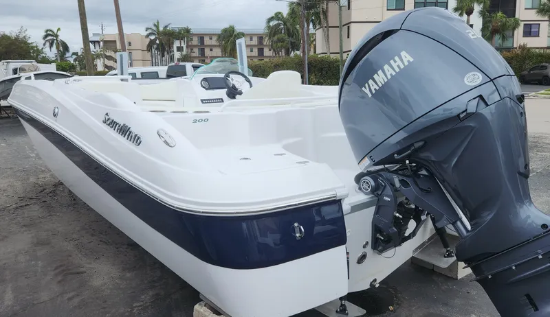 Slide: The Image of 2025 SouthWind 200 SD boat with Yamaha outboard motor, parked outdoors. - 1